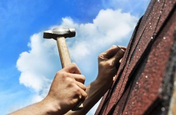 Hand With Hammer On Background Of Blue Sky Banner